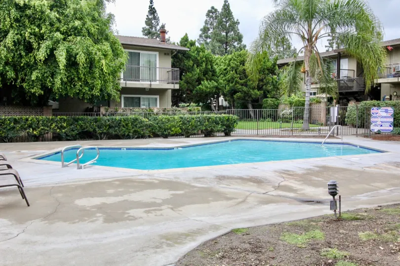 Beautiful Swimming pool at centre of villas with trees in Anaheim Village I of Anaheim