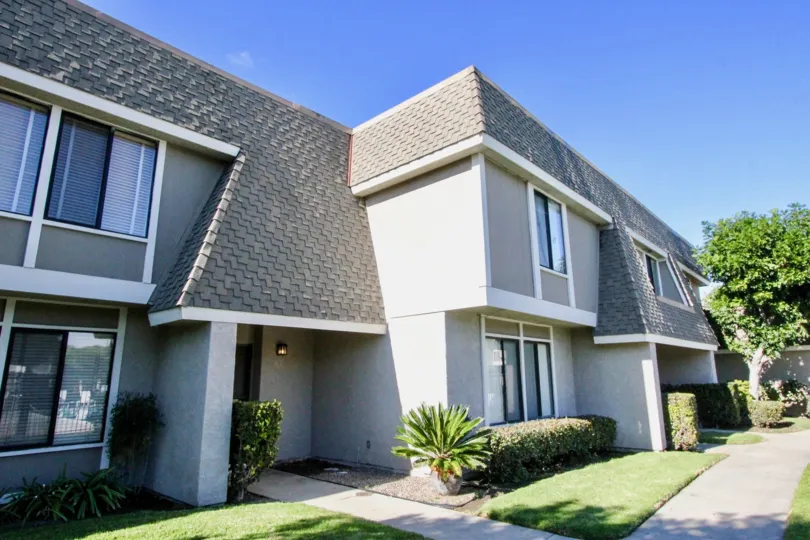 A side-view of a two-storey townhouse in the Broadmoor Arms community with pitched roof.