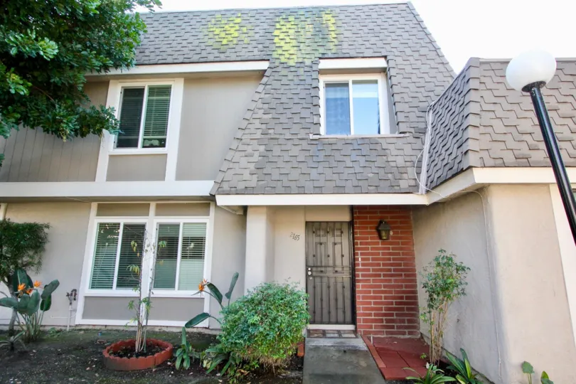 A two-storey residence in the Broadmoor Arms community with interlocking roof tiles.