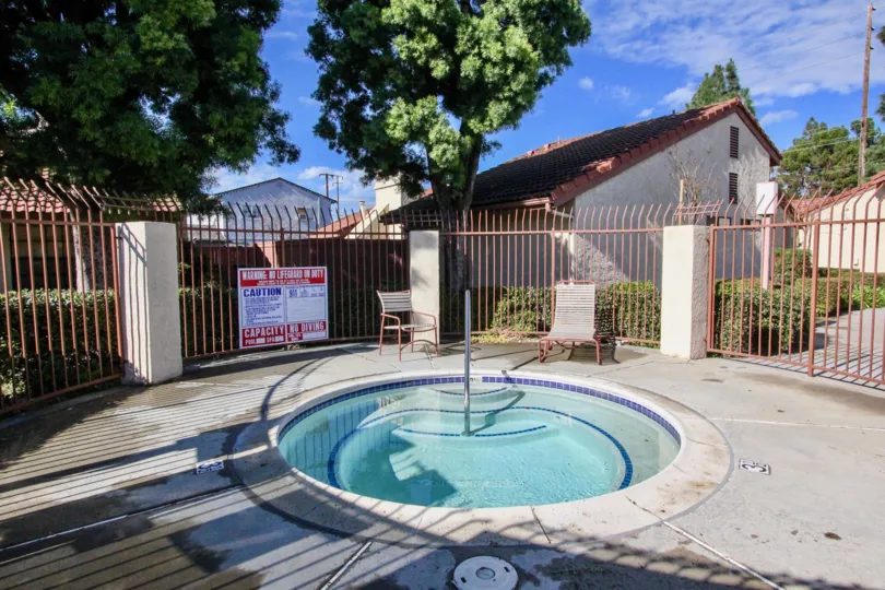 A small round pool in the Cameron Court with steel fences.