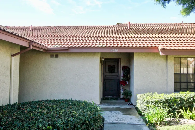 A simple bungalow in the Cameron Court community with tiled roofing.