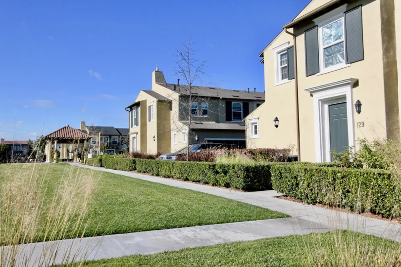 A large lawn area beside a row of individual bunglows inside Cantada square community