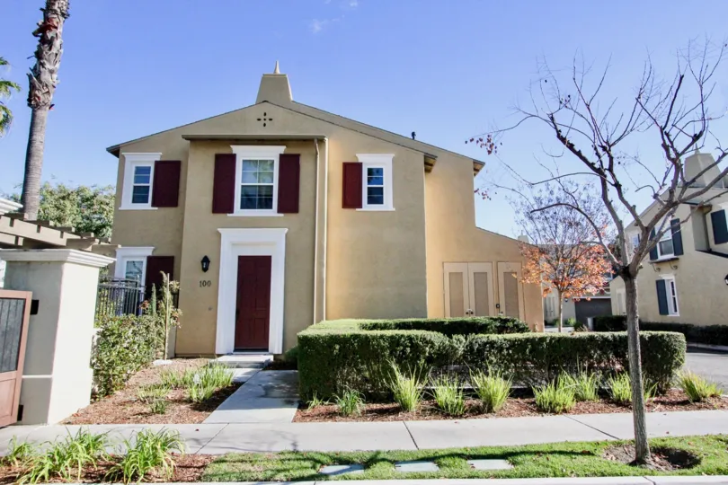 A street view of a home and front yard in Cantada Square on a sunny day