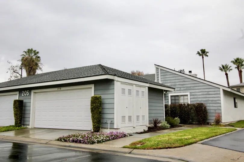 THE SHEDS WITH LAWN, CROTON PLANTS, NUMBER ON THE WALL ARE SHOWN IN ANAHEIM CITY