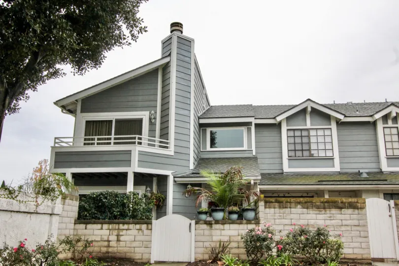 A two-storey residence in the Carbon Creek community with grayish wooden cladding.