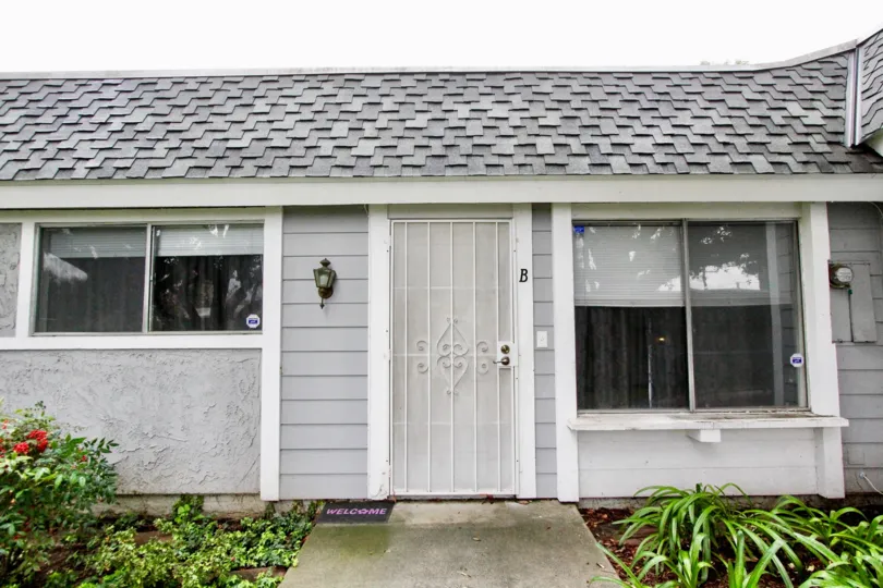 A bungalow in the Casa Canon community with sliding windows and gated front door.