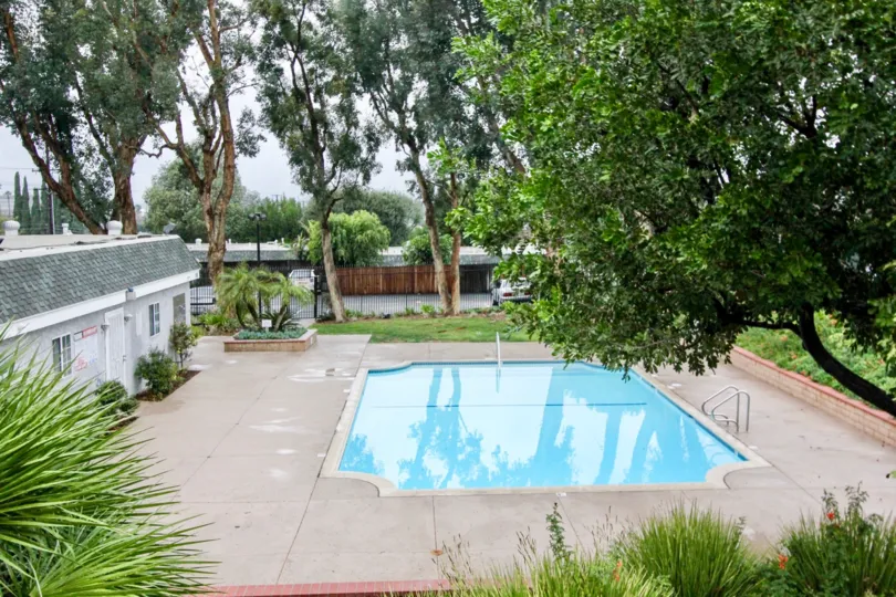 Nice Swimming pool with green trees around in Casa Canon of Anaheim