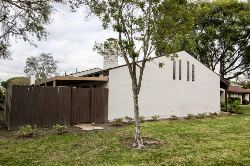 A white building with a brown fence in Casa Emperador community in Anaheim, California.