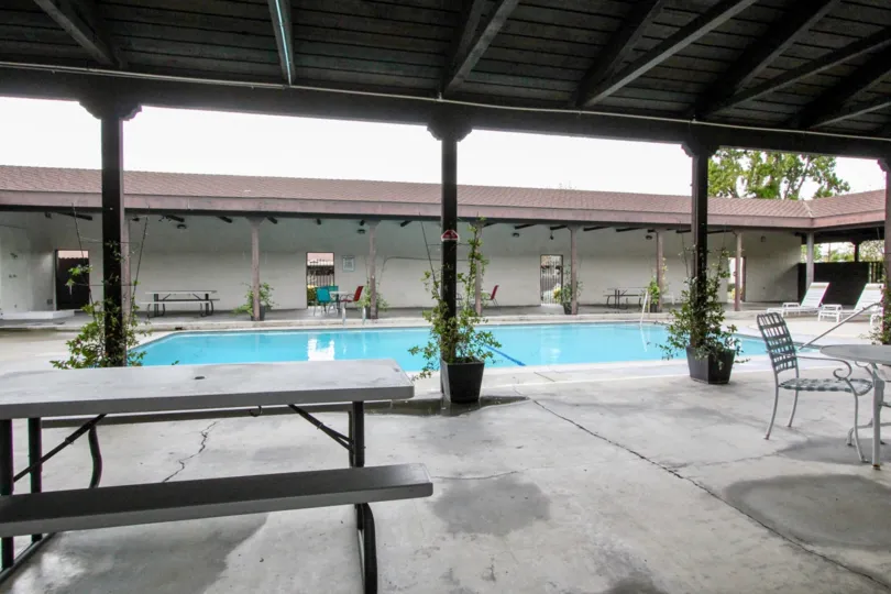Another side view of the Casa Emperador community pool with covered seating.