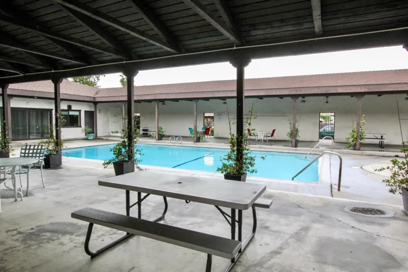A pool area inside Casa Emperador community surrounded by a porch
