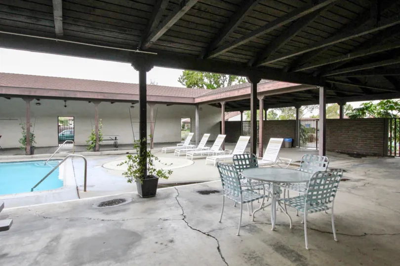 A covered seating area in the pool of the Casa Emperador community.