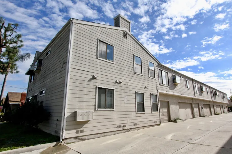 A plain two-storey apartments in the Cerritos Manor community with wooden cladding.