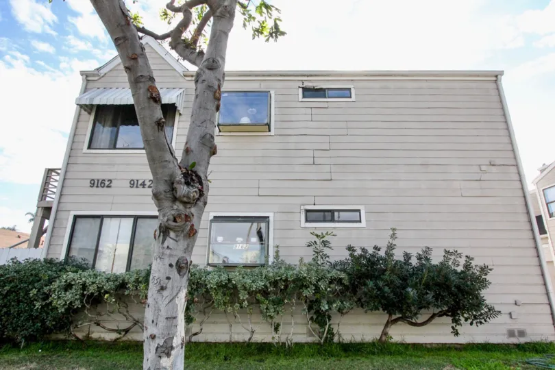 THE 9162, 9142 FLATS IN THE CERRITOS MANOR WITH THE GRASSLAND, PLANTS, TREES