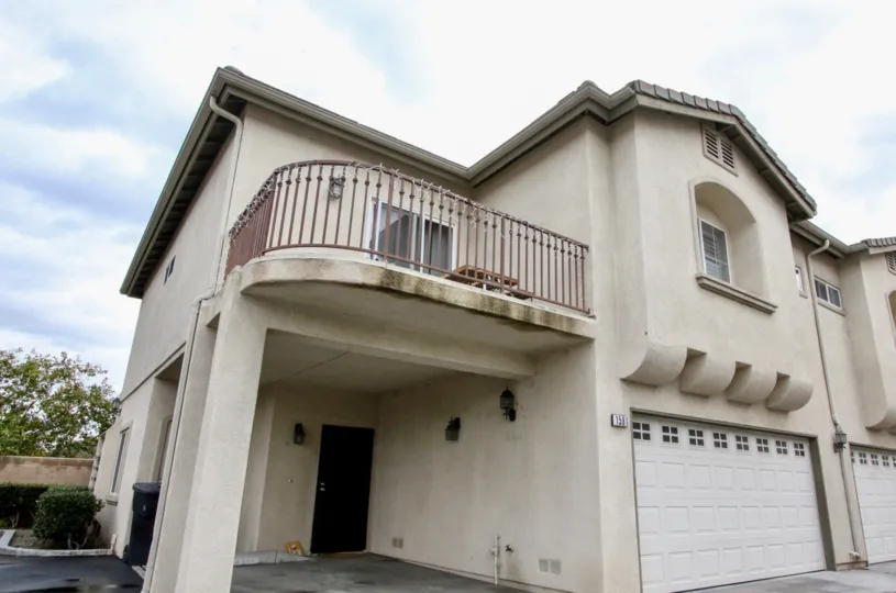 A large white home with garage in Citrus Villas community in Anaheim, California.