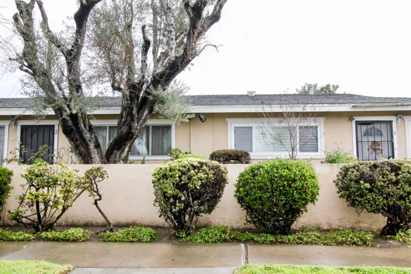 White one-story home with gray roof and garden in Coco Palms, Anaheim CA