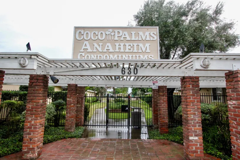 a pleasant day in the coco palms with park that has numbered as 630 and stone walls and entrance gate closed