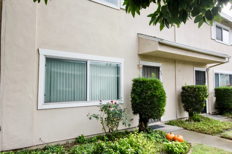 Beige, simple home with roses outside in Coco Palms, Anaheim CA