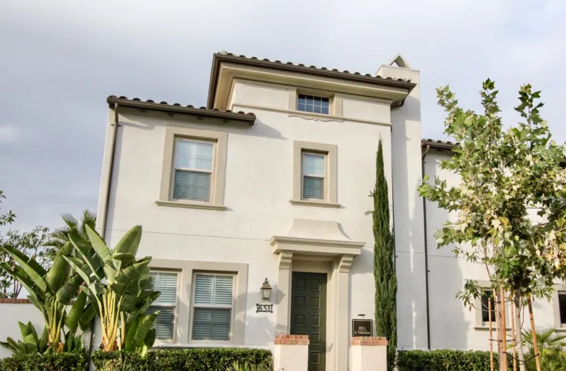 A large white home with plants around it in Colony Park community in Anaheim, California.