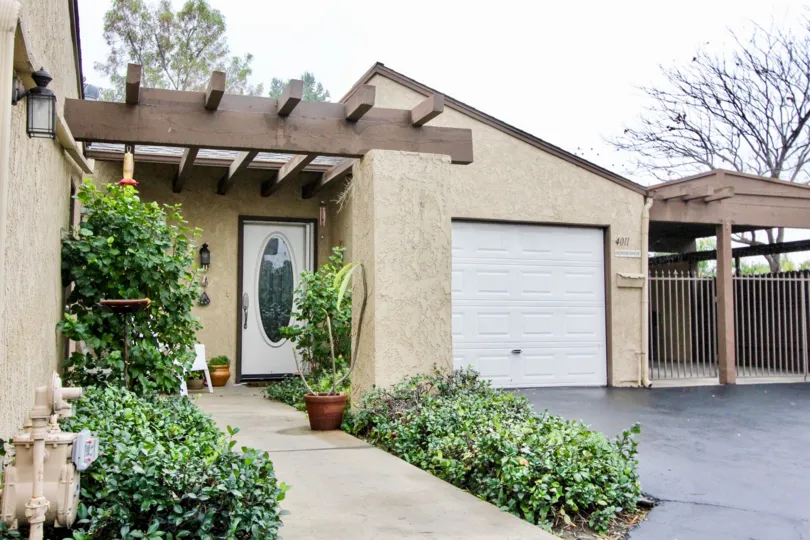 House in Gateway Americana community with elegant door, garden and parking area