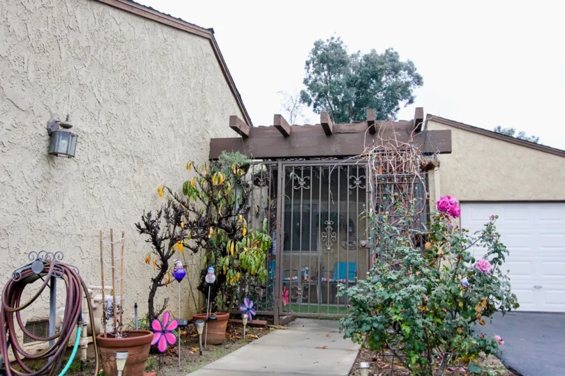 THIS IS THE ENTRANCE TO THE HOME WHICH SHOWS THE SOME PLANTS WITH FLOWERS IN THE ANAHEIM CITY