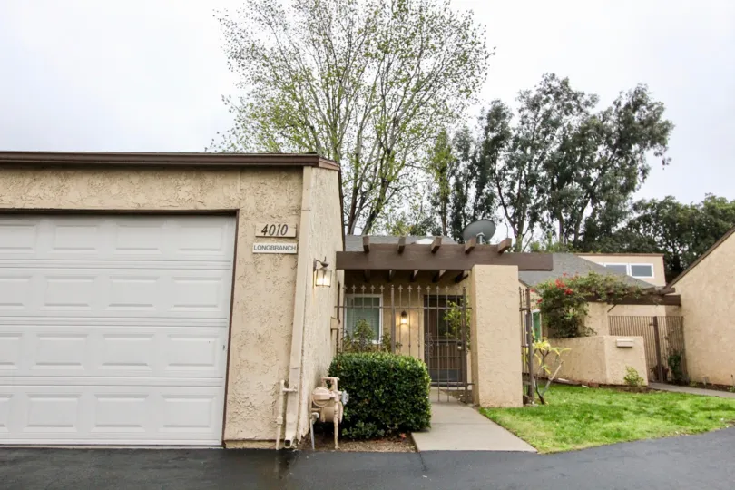 A house with a large garage and small lawn area inside Gateway Americana community
