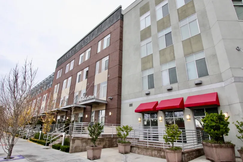 A row of commercial buildings in the Harbor Lofts community with brick and stone cladding.