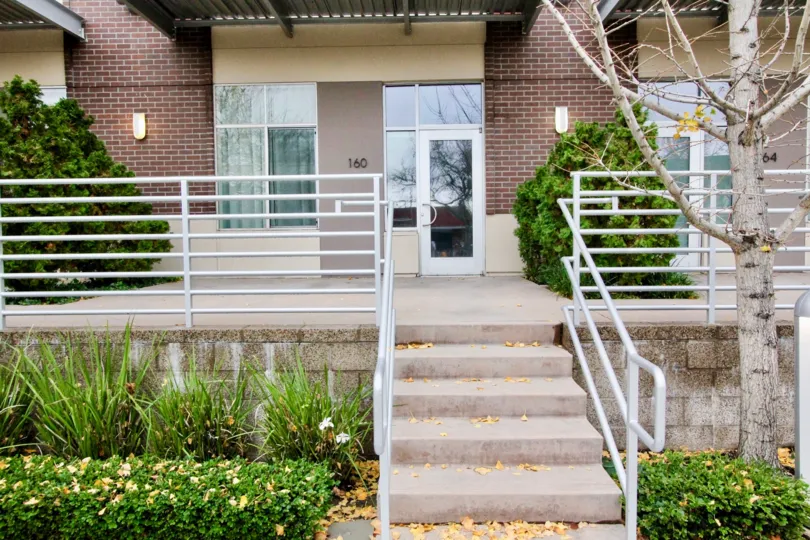 The front porch of a bunglow with steel railings at Harbor lofts