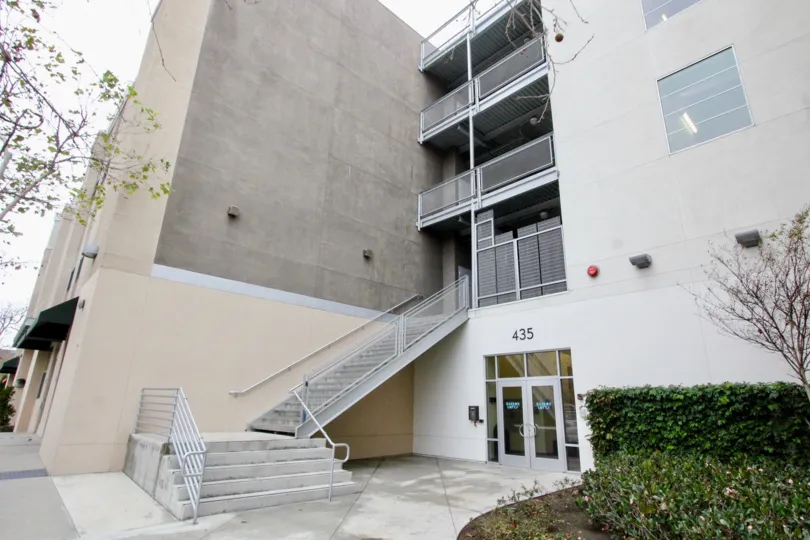 A four-storey building in the Harbor Lofts community with an exterior staircase.