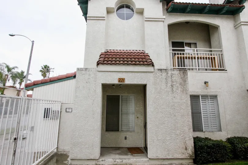 A large white house with red roof in La Vie En Rose community in Anaheim, California.