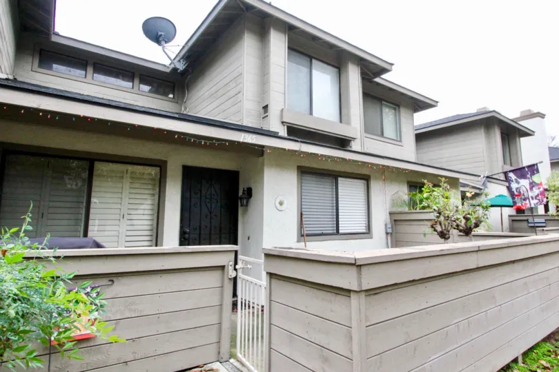 An ash color building Lakeview Townhomes with dish antenna.