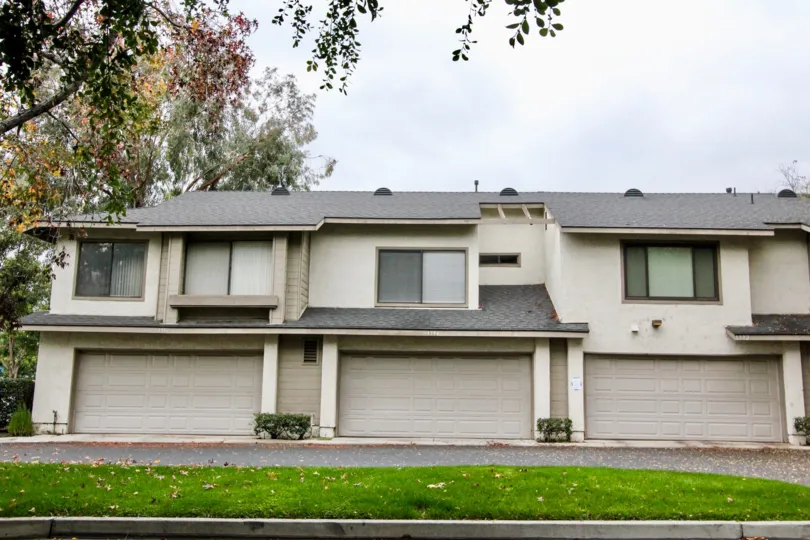 THE SIDE VIEW OF HOUSE WITH SHEDS, PATHWAY, LAWN AND TREES ARE THERE IN ANAHEIM CITY