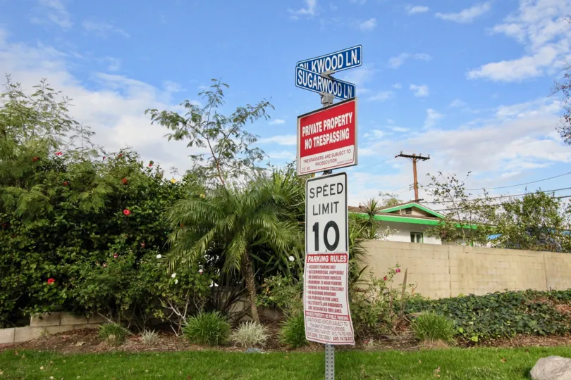 Signboards on the lawn of the Laurelwood Village community under the blue sky