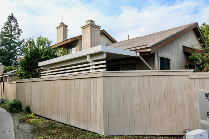 THE OUTSIDE OF THE HOUSE LOCATED IN ANAHEIM THAT HAVE THE LOT OF PLANTS AND TREES
