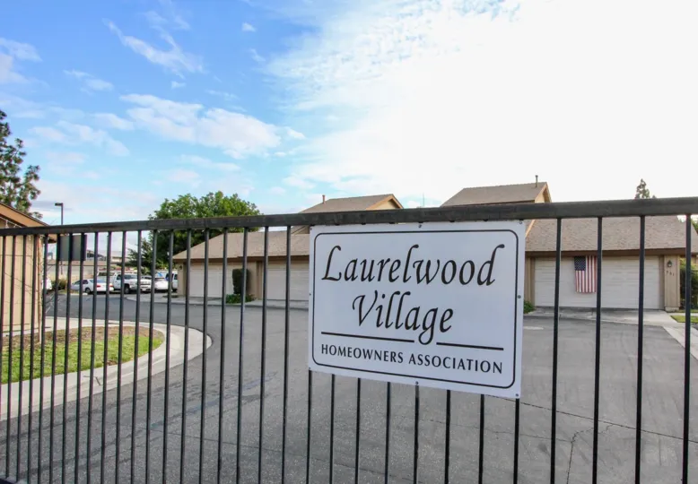 a pleasant day in the laurelwood village with a building that has parking 3 door closed and roofless top