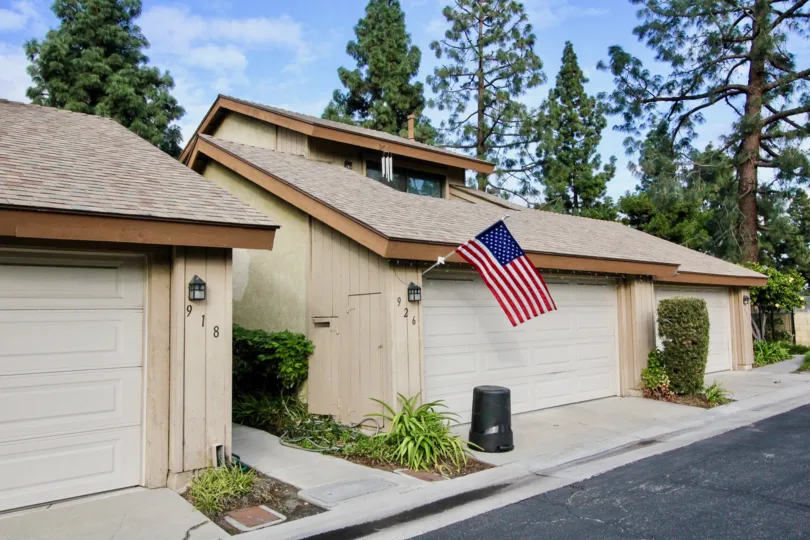 A sunny day in the Laurelwood Village with a small house and flag.