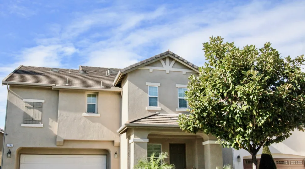 A sunny day in magnolia lane with beautiful villa and trees.