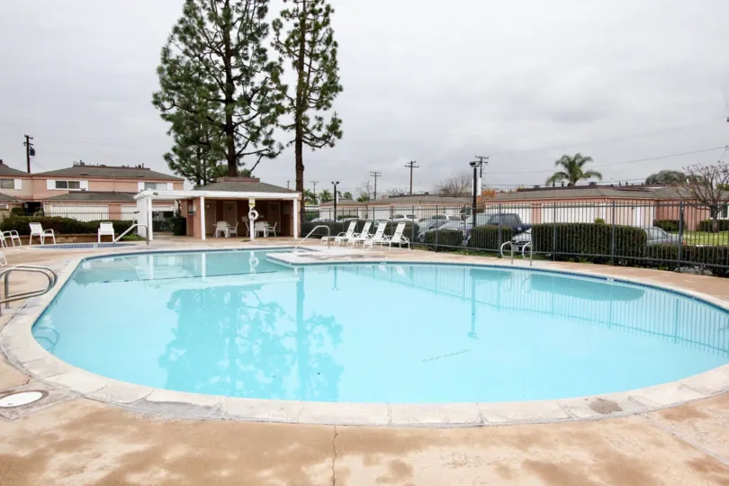 A cloudy day in the Northwoods Village swimming pool with fresh water surrounded by railing and resting chairs in place