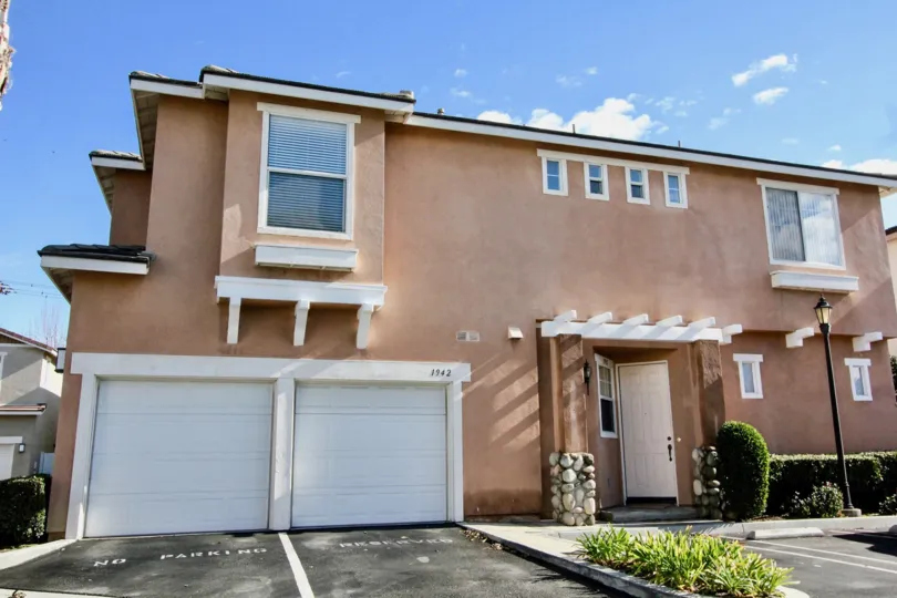 A sunndy day in the Peppertree Walk community featuring single car garages, Anaheim California.
