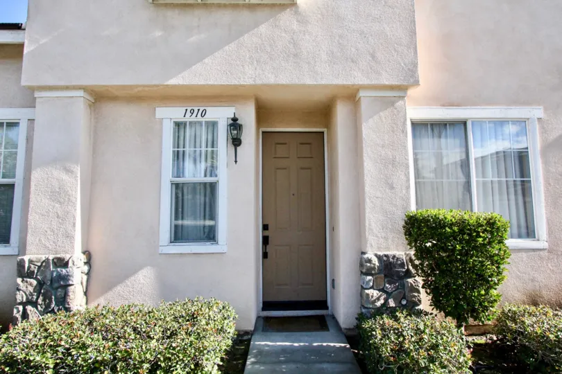 Front of a house with 1910 written on the Window in Peppertree Walk