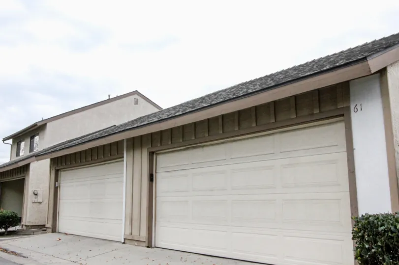 Two garage doors found in the Pepperwood Village Neighborhood of Anaheim, California on an overcast day.