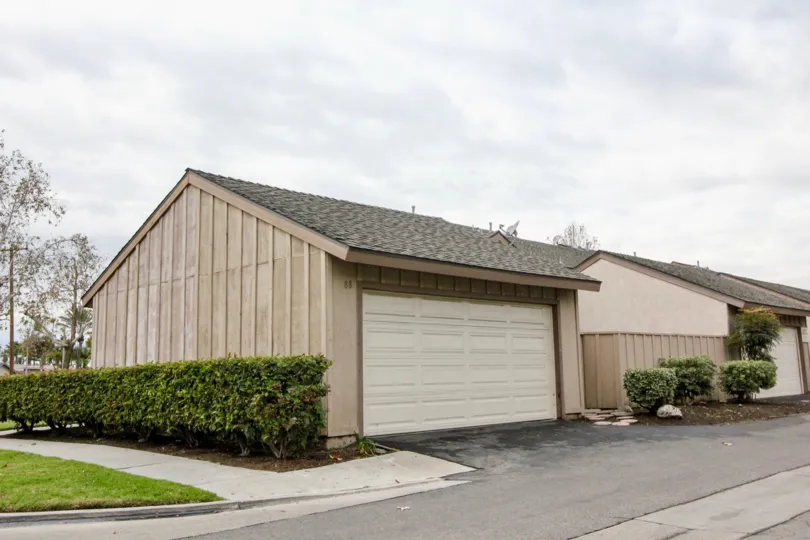 A home and garage viewed from the street on a cloudy day in the Pepperwood Village community