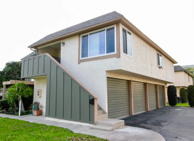 A side view of a house in the Ridgeway Park East with lawn.