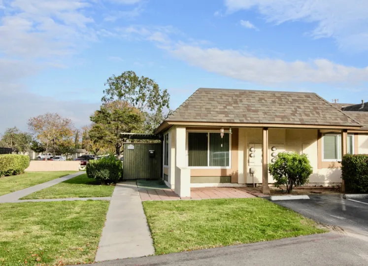a warm day in the ridgeway park east with a house that has garden around and entrance door closed