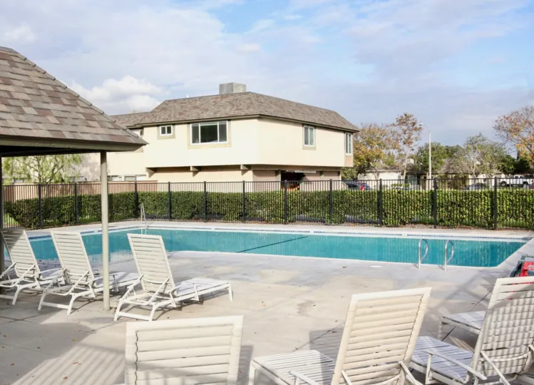 Swimming pool area with clean water and clean chair in Ridgeway park East of Anaheim
