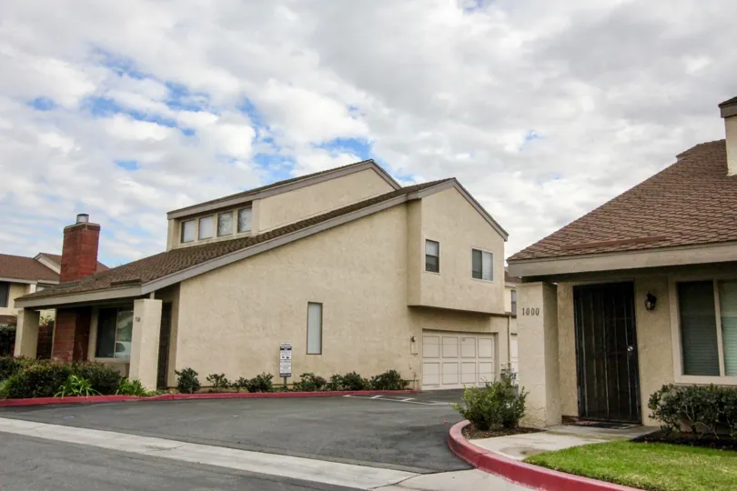 Street view of two homes, separated by a road, in Sherwood Village, Anaheim, CA
