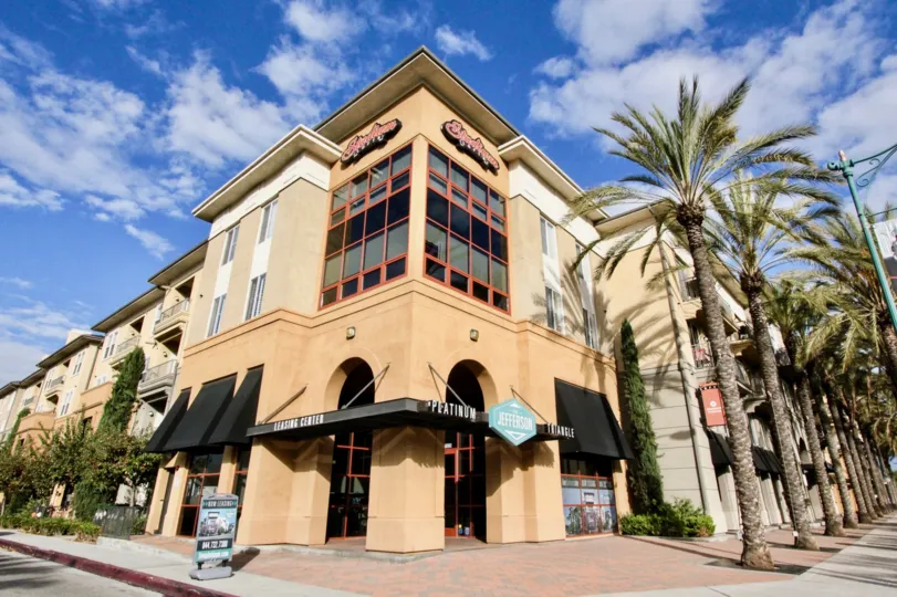 Leasing center called Platinum Triangle in Stadium Lofts has tall trees