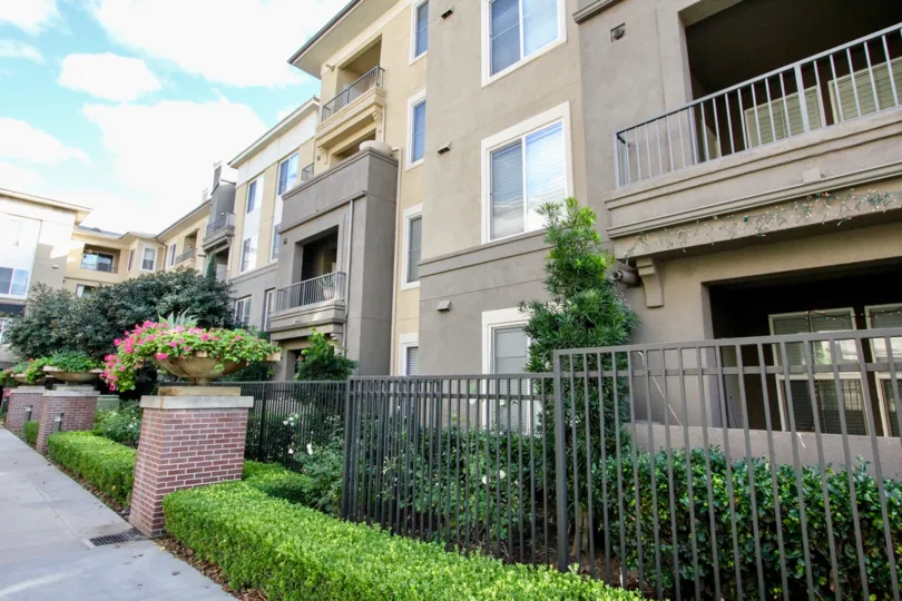 Gray and tan building featuring the front walkway and patios and decks on the Stadium Lofts neighborhood in Anaheim, California
