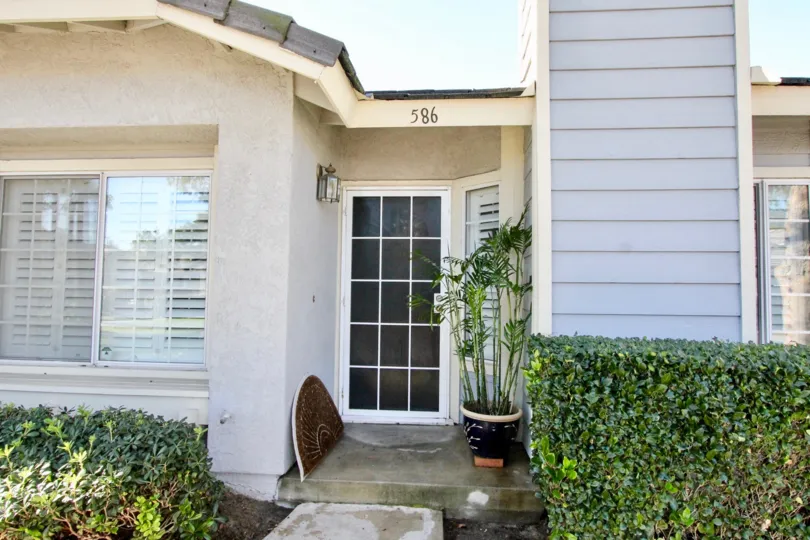 THE FRONT OF THE HOME NUMBER ON THE WALL, FRONT PLANTS, ARE VISIBLE IN THE STANFORD COURT COMMUNITY