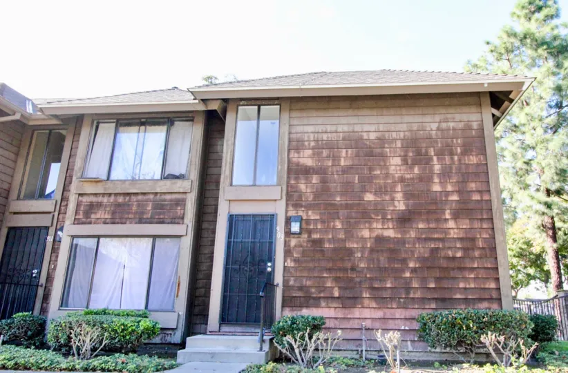 A sunny day in the Sutter Creek Townhomes with glass windows and plants.