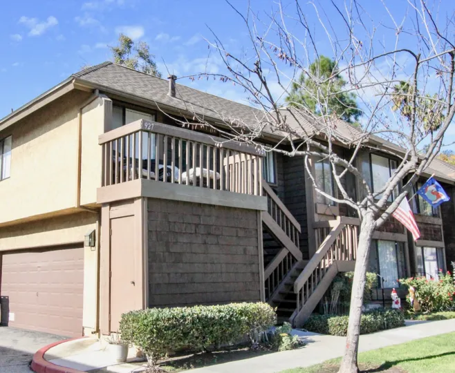 THE VILLA WITH SHED, WOODEN STEPS, TREES, NUMBER ON THE WALL, FLAGS ON THE TREE IN ANAHEIM CITY
